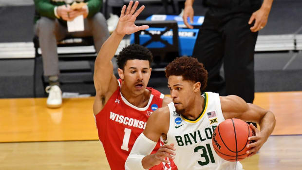 Mar 21, 2021; Indianapolis, Indiana, USA; Baylor Bears guard MaCio Teague (31) dribbles as Wisconsin Badgers guard Jonathan Davis (1) pursues during the second half in the second round of the 2021 NCAA Tournament at Hinkle Fieldhouse. The Baylor Bears won 76-63. Mandatory Credit: Patrick Gorski-USA TODAY Sports